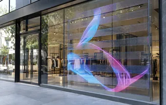 Transparent LED display on retail glazing with the shop interior visible through it