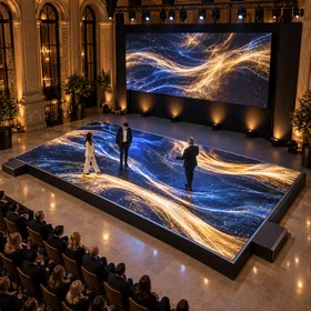 A reusable LED floor displaying gold and blue event graphics at a product launch